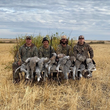 Group of hunters dressed in camo holding rifles